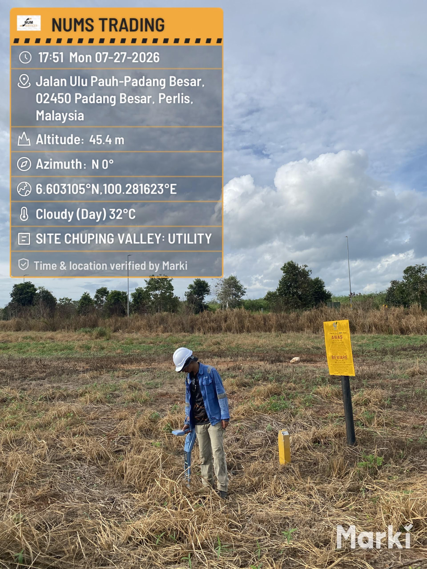 Surveyor tracing an underground cable route with a locator at Chuping Valley, Perlis